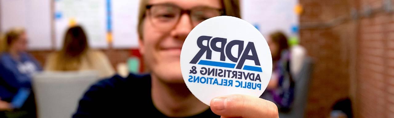 GVSU Student holds up ADPR button